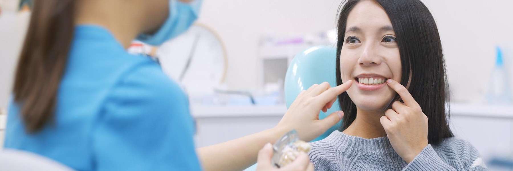 Smiling patient receiving a dental consultation about her teeth alignment and oral health at a moder