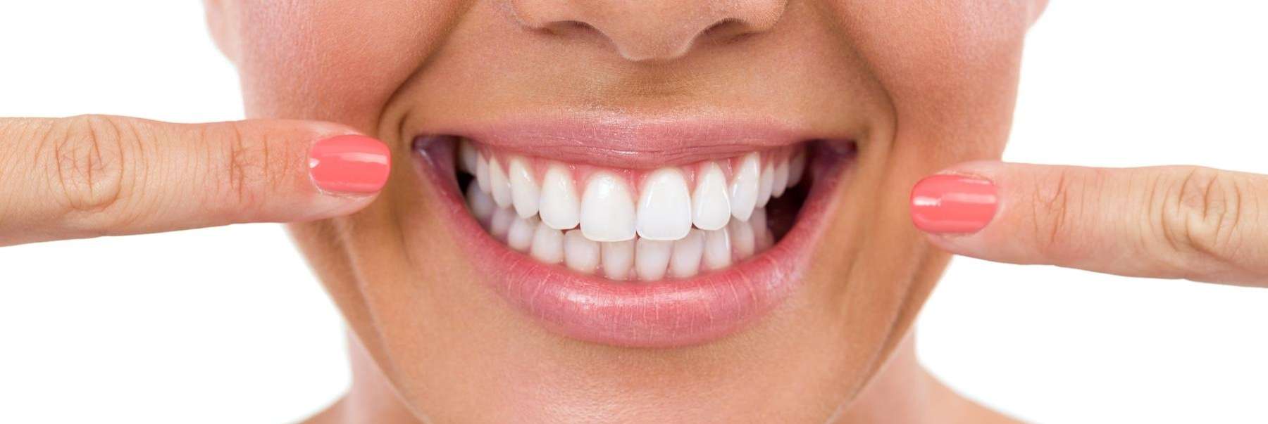 woman showing off her teeth whitening results in aurora